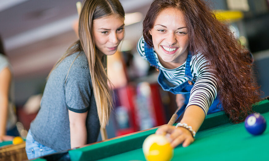 Two friends playing pool